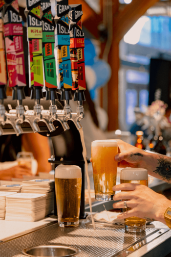 person with granville beer in a glass